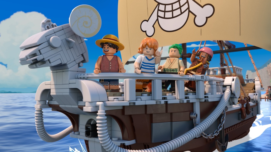 "Four LEGO minifigures stand on the deck of a detailed LEGO ship, sailing on blue ocean under a bright sky, with a skull-and-crossbones sail."